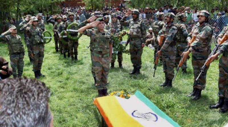Army personnel paying tribute to the slain army officer Lt. Ummer Fayyaz during his funeral at his native village Sudsona in Kulgam district. (Photo: PTI) Army personnel paying tribute to the slain army officer Lt. Ummer Fayyaz during his funeral at his native village Sudsona in Kulgam district. (Photo: PTI)