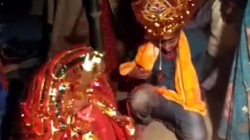 Video clips from the wedding show Vinod Kumar, the forced groom, being thrashed and compelled to perform wedding rituals in Patna's Pandarak area. (Screengrab) Video clips from the wedding show Vinod Kumar, the forced groom, being thrashed and compelled to perform wedding rituals in Patna's Pandarak area. (Screengrab)