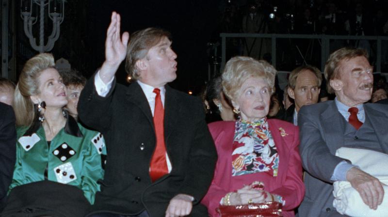 Donald Trump (center) waves to staff members of the Trump Taj Mahal Casino Resort as they cheer him on before the grand opening ceremonies in Atlantic City. Trump attended the gala with his mother, Mary; father, Fred; and sister, U.S. District Court Judge Maryanne Trump Barry, right. (AP File)
