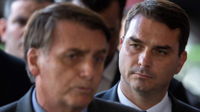 Jair Bolsonaro (L) and his son Flavio Bolsonaro (R). (AFP)