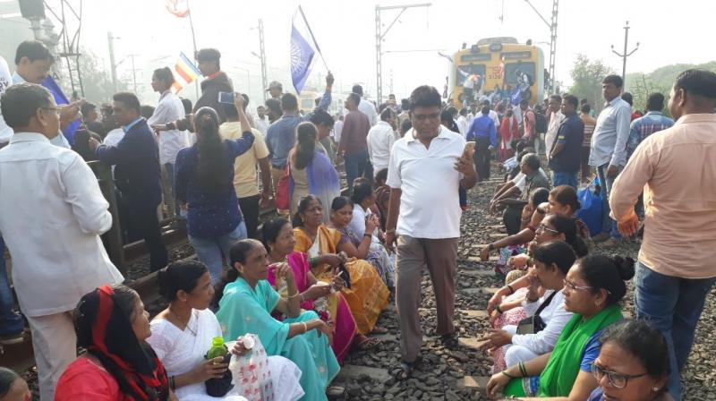 Protesters seen occupying the railway tracks at Nallasopara station, Mumbai. (Photo: ANI/Twitter) Protesters seen occupying the railway tracks at Nallasopara station, Mumbai. (Photo: ANI/Twitter)