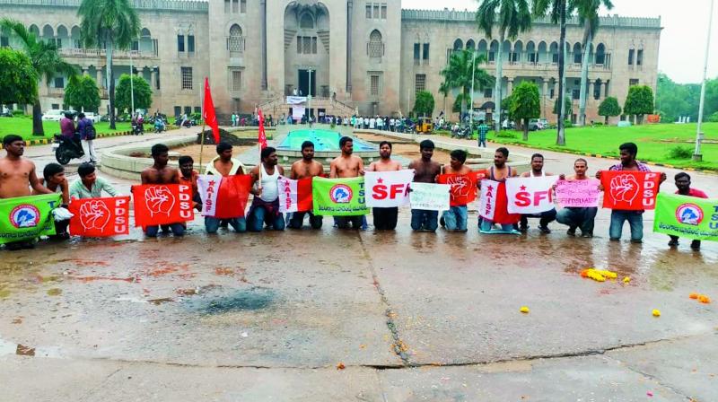 Representatives of student unions at Osmania University protest by removing their shirts at the Arts College campus in Hyderabad in support of the ongoing agitation by the RTC employees on Wednesday. Representatives of student unions at Osmania University protest by removing their shirts at the Arts College campus in Hyderabad in support of the ongoing agitation by the RTC employees on Wednesday.