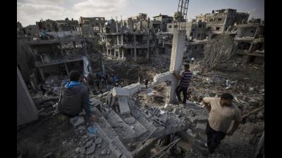 Palestinians inspect their destroyed houses following overnight Israeli airstrikes in town of Beit Hanoun, northern Gaza Strip, Friday, May 14, 2021. (AP Photo/Khalil Hamra)