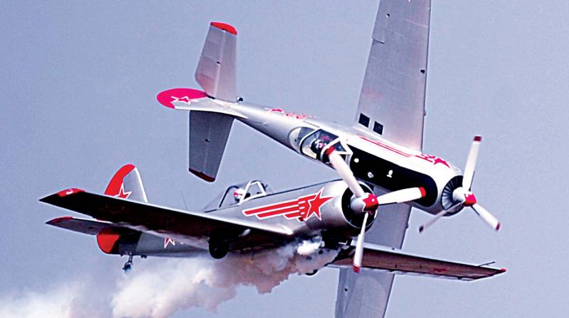 People watch a Scandinavian Air Show aircraft take off; UK’s Yakovlevs aerobatics team performs a stunt (Photo: R. Samuel) People watch a Scandinavian Air Show aircraft take off; UK’s Yakovlevs aerobatics team performs a stunt (Photo: R. Samuel)