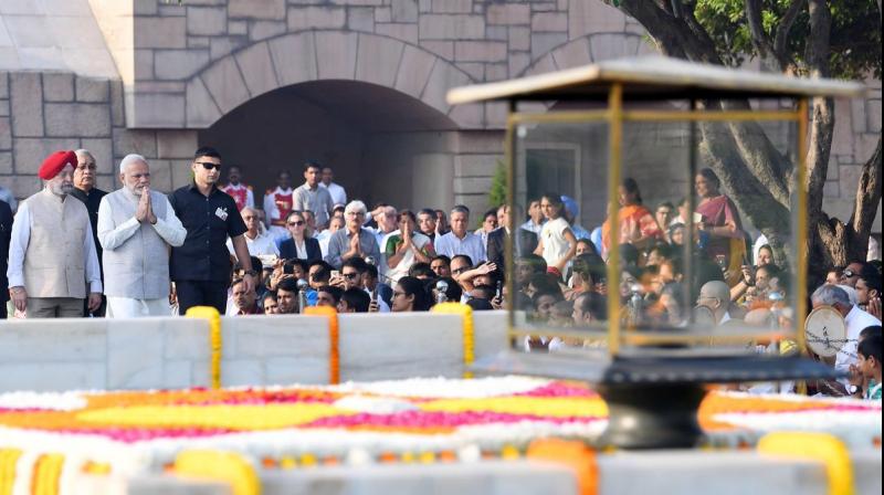 Prime Minister Narendra Modi paid tributes to Mahatma Gandhi on his 149th birth anniversary at Rajghat in New Delhi. (Photo: Twitter | @narendramodi) Prime Minister Narendra Modi paid tributes to Mahatma Gandhi on his 149th birth anniversary at Rajghat in New Delhi. (Photo: Twitter | @narendramodi)