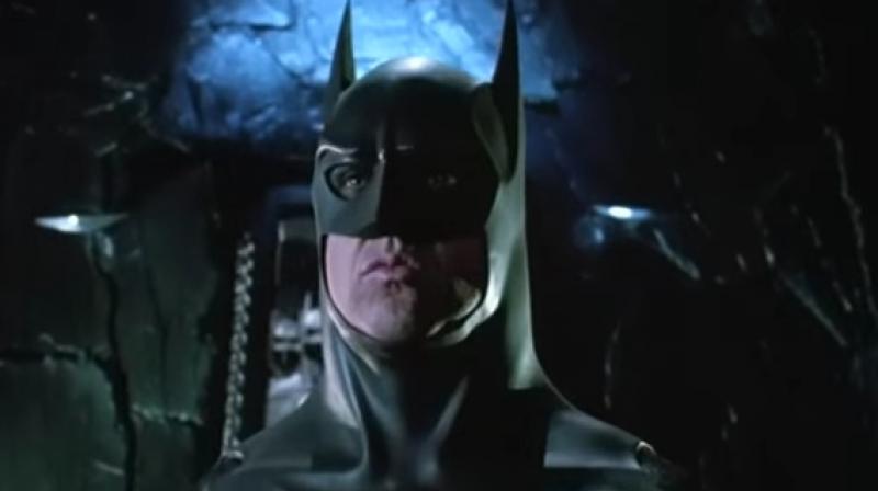 The costume is displayed on a mannequin with the chiseled likeness of Keaton and stands at approximately 6-foot-5 and is displayed on a 2-inch gray and white mounted base with Batman Returns titled on the front center. (Photo: Youtube) The costume is displayed on a mannequin with the chiseled likeness of Keaton and stands at approximately 6-foot-5 and is displayed on a 2-inch gray and white mounted base with Batman Returns titled on the front center. (Photo: Youtube)