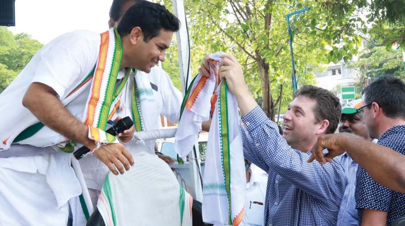 Nick Wakeling, Liberal Party member of the Victorian Legislative Assembly draping a shawl on Hibi Eden during his election campaign in Vennala on Wednesday in Kochi. Nick Wakeling, Liberal Party member of the Victorian Legislative Assembly draping a shawl on Hibi Eden during his election campaign in Vennala on Wednesday in Kochi.
