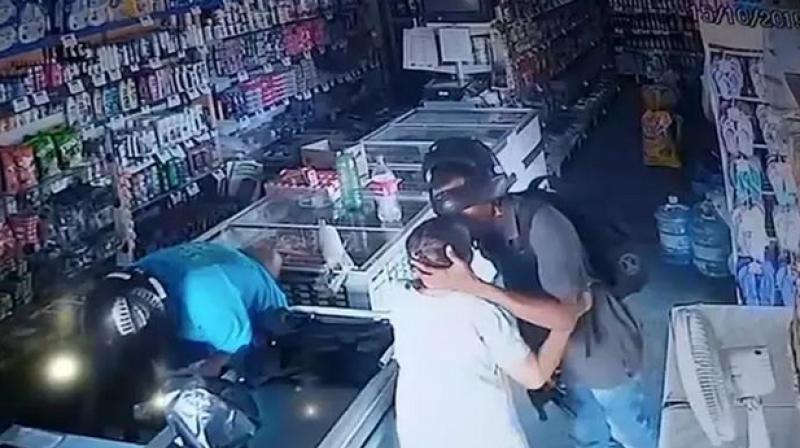 'He kissed her and said, 'No, ma'am, you can be quiet, I don't want your money,' shop owner said. (Photo: Screengrab) 'He kissed her and said, 'No, ma'am, you can be quiet, I don't want your money,' shop owner said. (Photo: Screengrab)