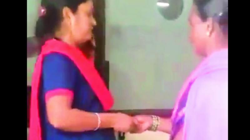 A video grab of a security guard accepting a bribe from an attendant of a patient at the government maternity hospital in Petlaburj. A video grab of a security guard accepting a bribe from an attendant of a patient at the government maternity hospital in Petlaburj.