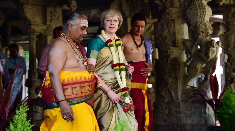 British Prime Minister Theresa May, donning a saari, visits the Someshwara temple in Bengaluru on Tuesday. (Photo: PTI) British Prime Minister Theresa May, donning a saari, visits the Someshwara temple in Bengaluru on Tuesday. (Photo: PTI)