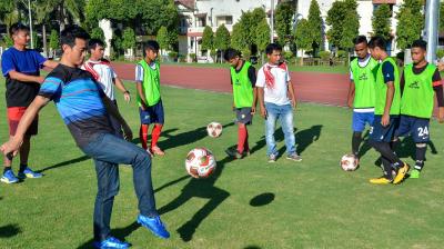 Bhaichung Bhutia plays with aspiring footballers at Paltan Bazar in Guwahati. PTI Photo