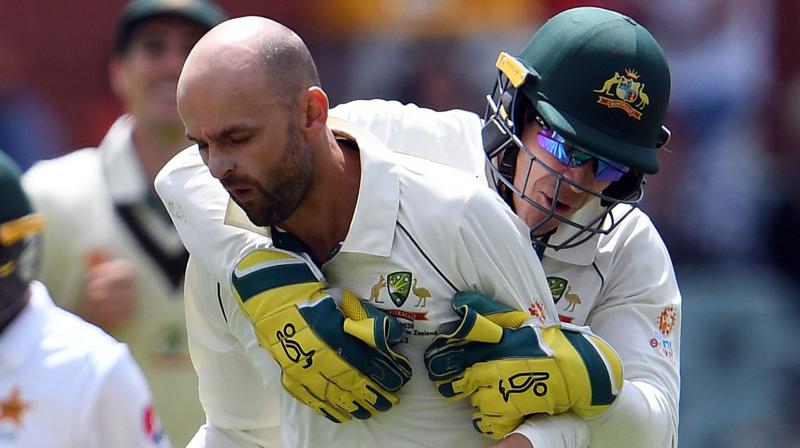 Nathan Lyon celebrates his wicket with captain and wicket-keeper Tim Paine. AFP Photo Nathan Lyon celebrates his wicket with captain and wicket-keeper Tim Paine. AFP Photo