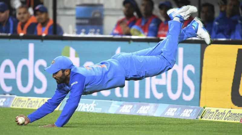 Dinesh Karthik takes an acrobatic catch to dismiss New Zealands Daryl Mitchell in the Twenty/20 international in New Zealand last year. AP Photo