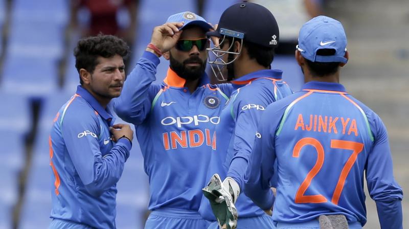 Kuldeep Yadav listens to skipper MS Dhoni as Virat Kohli and Ajinkya Rahane look on. AP Photo