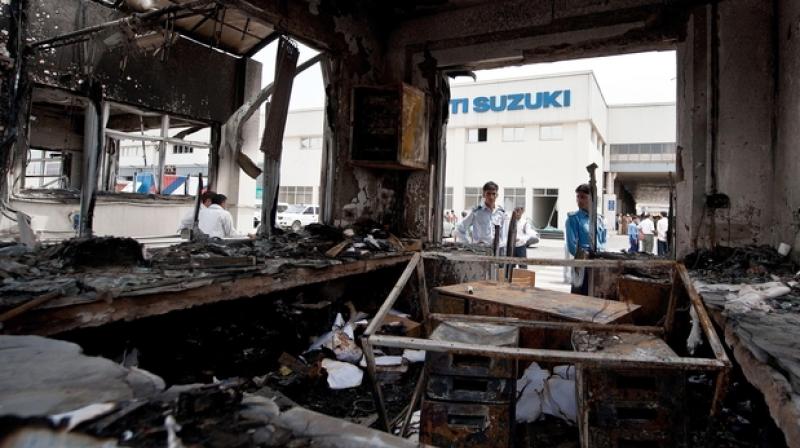The violence on August 18, 2012 broke out over wage issues when a group of employees allegedly torched a section of MSIL facility. (Photo: AFP) The violence on August 18, 2012 broke out over wage issues when a group of employees allegedly torched a section of MSIL facility. (Photo: AFP)