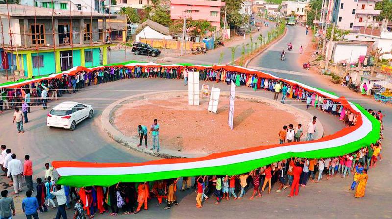 The 104-metre-long National Flag displayed in Madhira by Vibrant Kalam organisation on the occasion of National Voters’ Day in Khammam on Thursday. (Photo: DC) The 104-metre-long National Flag displayed in Madhira by Vibrant Kalam organisation on the occasion of National Voters’ Day in Khammam on Thursday. (Photo: DC)