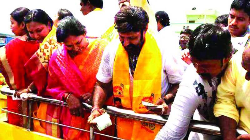 Videograb shows Balakrishna handing over cash at Nandyal Videograb shows Balakrishna handing over cash at Nandyal