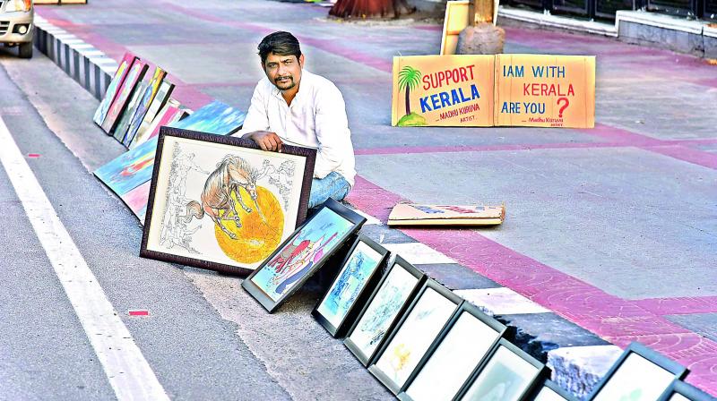 Madhu Karuva displaying his art work. Madhu Karuva displaying his art work.
