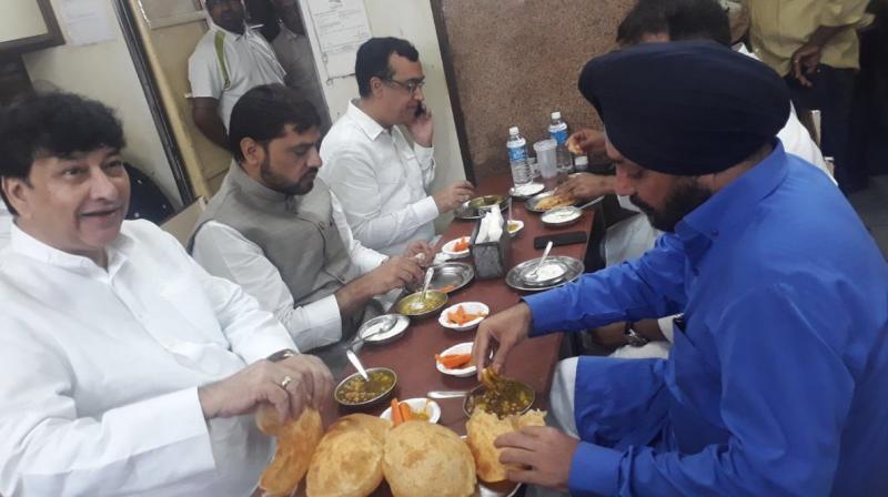 As the protest started, an image of Congress leaders including Ajay Maken, Haroun Yusuf and Arvinder Singh Lovely, gobbling down chhole bhaturas and other Delhi delicacies at a popular restaurant started doing the rounds. (Photo: ANI | Twitter) As the protest started, an image of Congress leaders including Ajay Maken, Haroun Yusuf and Arvinder Singh Lovely, gobbling down chhole bhaturas and other Delhi delicacies at a popular restaurant started doing the rounds. (Photo: ANI | Twitter)