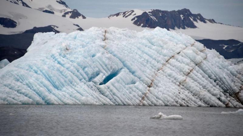 The Arctic is mostly ocean covered with a layer of ice; changes from ice to water often kick in a cycle that contributes to global warming. The Arctic is mostly ocean covered with a layer of ice; changes from ice to water often kick in a cycle that contributes to global warming.