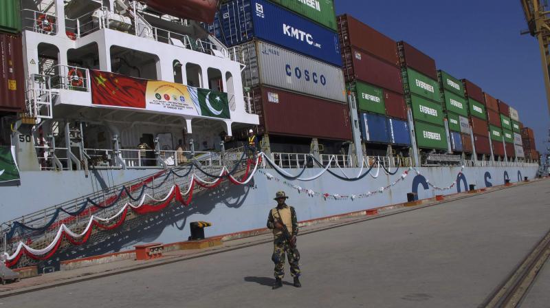 A Pakistan Navy soldier stands guard while a loaded Chinese ship prepares to depart at Gwadar port (Photo: AP) A Pakistan Navy soldier stands guard while a loaded Chinese ship prepares to depart at Gwadar port (Photo: AP)