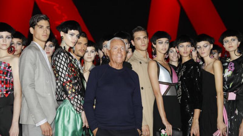 Designer Giorgio Armani, centre, poses with models at the end of his womens Fall/Winter 2018/19 fashion collection, presented in Milan, Italy, Friday, Sept. 22, 2017. Designer Giorgio Armani, centre, poses with models at the end of his womens Fall/Winter 2018/19 fashion collection, presented in Milan, Italy, Friday, Sept. 22, 2017.