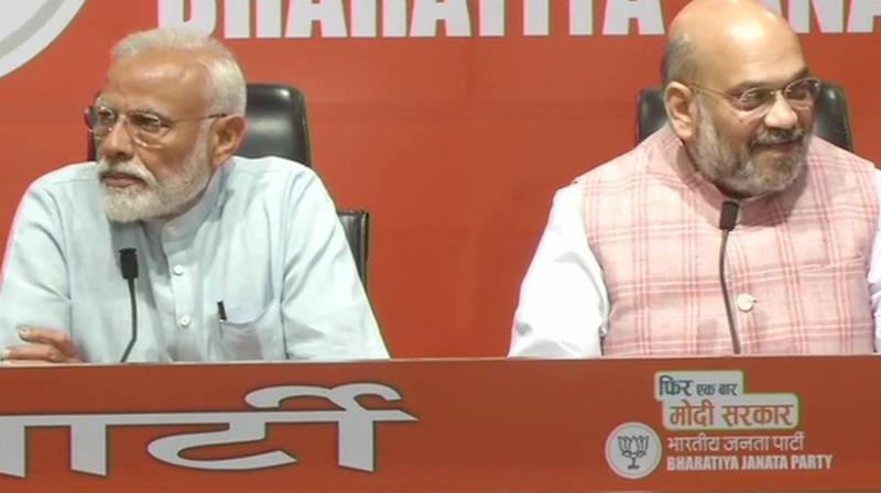 PM Narendra Modi and BJP chief Amit Shah addressing the press conference. (Photo: ANI) PM Narendra Modi and BJP chief Amit Shah addressing the press conference. (Photo: ANI)