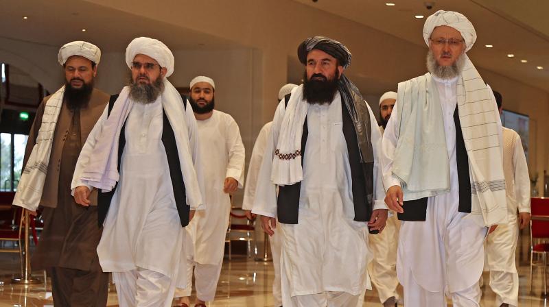 In this file photo taken on August 12, 2021, Head of the Taliban delegation Abdul Salam Hanafi (R), accompanied by Taliban officials (2R to L) Muttaqi, Shahabuddin Delawar and Abdul Latif Mansour, walks down a hotel lobby during the talks in Doha. (KARIM JAAFAR / AFP)