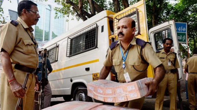 Currency notes being carried from a bank chest amid tight security. (Photo: PTI) Currency notes being carried from a bank chest amid tight security. (Photo: PTI)