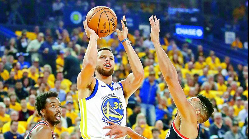 Stephen Curry of the Golden State Warriors shoots the ball against CJ McCollum (right) of the Portland Trail Blazers during the first half in game one of the NBA Western Conference Finals at Oracle Arena in Oakland, California on Wednesday. (Photo - AFP) Stephen Curry of the Golden State Warriors shoots the ball against CJ McCollum (right) of the Portland Trail Blazers during the first half in game one of the NBA Western Conference Finals at Oracle Arena in Oakland, California on Wednesday. (Photo - AFP)