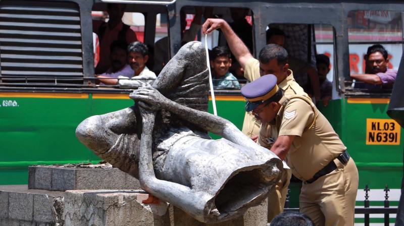 The statue broke into two parts in the impact of the fall and its head portion was lying on the ground The statue broke into two parts in the impact of the fall and its head portion was lying on the ground