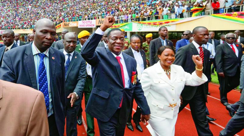 Emmerson Mnangagwa, center, and his wife Auxillia, center-right, arrive at the Presidential inauguration ceremony in Harare on Friday. (Photo: AFP) Emmerson Mnangagwa, center, and his wife Auxillia, center-right, arrive at the Presidential inauguration ceremony in Harare on Friday. (Photo: AFP)