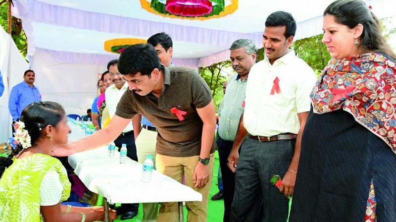 Guntur collector K. Sasidhar, Guntur Urban SP Ch. Vijaya Rao and JC Kritika Sukla interact with children affected by AIDS during 'My Health - My Right' programme held marking the World AIDS Day in Guntur on Friday. (Photo: DC) Guntur collector K. Sasidhar, Guntur Urban SP Ch. Vijaya Rao and JC Kritika Sukla interact with children affected by AIDS during 'My Health - My Right' programme held marking the World AIDS Day in Guntur on Friday. (Photo: DC)