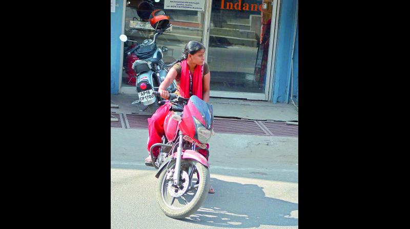 A girl drives a two-wheeler in Vijayawada. (Photo: DC) A girl drives a two-wheeler in Vijayawada. (Photo: DC)