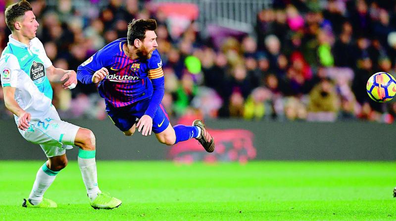Lionel Messi (right) and Deportivo La Coruna’s Fabian Schaer eye the ball during their Spanish league football match at the Camp Nou stadium in Barcelona on Sunday. Barcelona won 4-0. (Photo: AFP) Lionel Messi (right) and Deportivo La Coruna’s Fabian Schaer eye the ball during their Spanish league football match at the Camp Nou stadium in Barcelona on Sunday. Barcelona won 4-0. (Photo: AFP)
