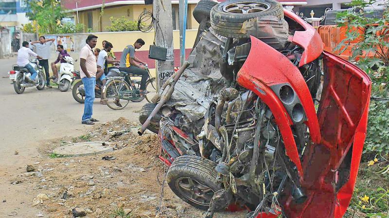 The car which fell of the Irumbuliyur bypass lies in crumbles. (Photo: DC) The car which fell of the Irumbuliyur bypass lies in crumbles. (Photo: DC)
