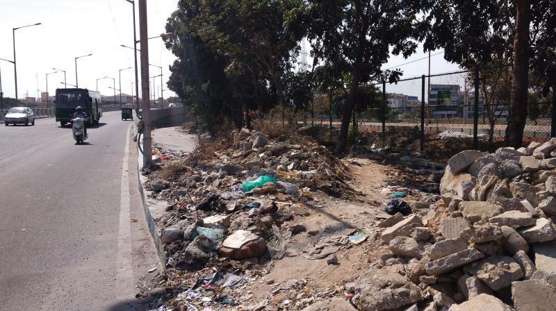 The debris dumped by civic agencies under the flyover at ORR has created a miserable situation for pedestrians. (Photo:DC) The debris dumped by civic agencies under the flyover at ORR has created a miserable situation for pedestrians. (Photo:DC)