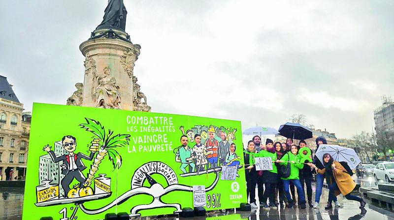 Militants of Oxfam France demonstrate on Monday on the Place de la Republique (Republic Square) in Paris for the launching of the campaign against inequality. (Photo:AFP) Militants of Oxfam France demonstrate on Monday on the Place de la Republique (Republic Square) in Paris for the launching of the campaign against inequality. (Photo:AFP)