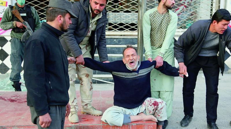 A relative of a victim is helped as he cries after a deadly suicide attack in Kabul on Saturday, when a bomb placed in an ambulance exploded killing at least 95 persons and wounding over 100. The attack has been claimed by the Taliban. (Photo: AP) A relative of a victim is helped as he cries after a deadly suicide attack in Kabul on Saturday, when a bomb placed in an ambulance exploded killing at least 95 persons and wounding over 100. The attack has been claimed by the Taliban. (Photo: AP)