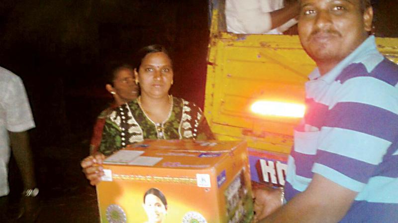 A cooker packed in a gift box with the photo of Congress leader Laxmi Hebbalkar being given to a voter in Belagavi Rural constituency A cooker packed in a gift box with the photo of Congress leader Laxmi Hebbalkar being given to a voter in Belagavi Rural constituency