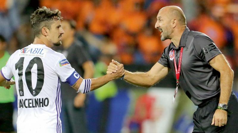 FC Pune City’s Marcelinho is congratulated by coach Ranko Popovic after their ISL-4 match in Mumbai. FC Pune City’s Marcelinho is congratulated by coach Ranko Popovic after their ISL-4 match in Mumbai.