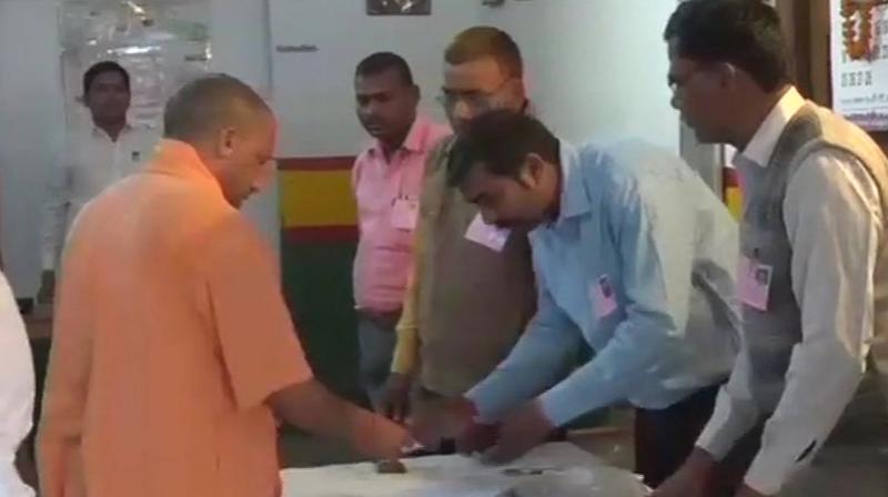 Uttar Pradesh Chief Minister Yogi Adityanath casts his vote for Gorakhpur bypolls at a polling station, says 'For development and good governance, BJP is necessary.' (Photo: ANI/Twitter) Uttar Pradesh Chief Minister Yogi Adityanath casts his vote for Gorakhpur bypolls at a polling station, says 'For development and good governance, BJP is necessary.' (Photo: ANI/Twitter)