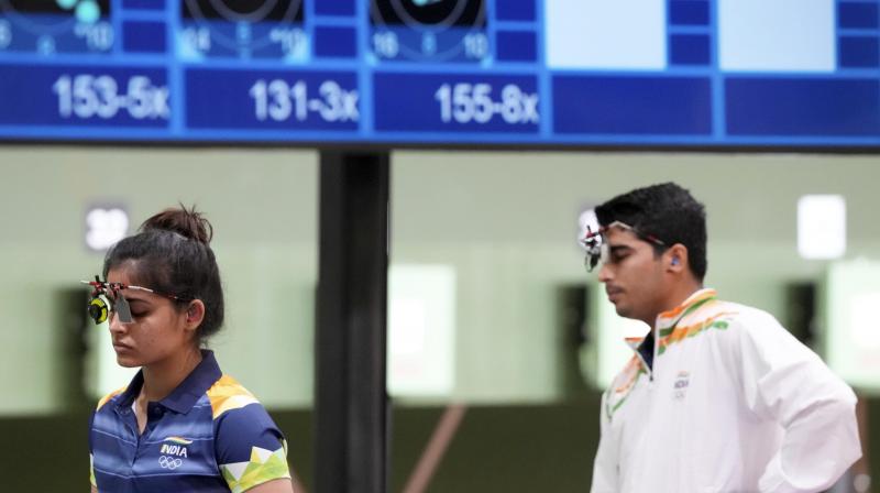 India's Manu Bhaker and Saurabh Chaudhary during the 10m Air Pistol Mixed Team event at the Summer Olympics in Tokyo on Tuesday. (PTI Photo) India's Manu Bhaker and Saurabh Chaudhary during the 10m Air Pistol Mixed Team event at the Summer Olympics in Tokyo on Tuesday. (PTI Photo)