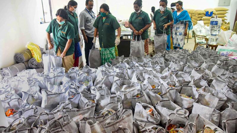 Kochi: Workers arrange sacks containing essential items, provided by the government, during a nationwide lockdown in the wake of coronavirus pandremic, in Kochi, Thursday, April 2, 2020. (PTI)