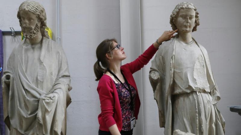 Heritage Curator of the Centre for Research and Restoration of Museums of France (C2RMF) Alexandre Gérard examines polychrome stone statues belonging to the Museum of Cluny, the Heritage Curator of the Centre for Research and Restoration of Museums of France (C2RMF) Alexandre Gérard examines polychrome stone statues belonging to the Museum of Cluny, the