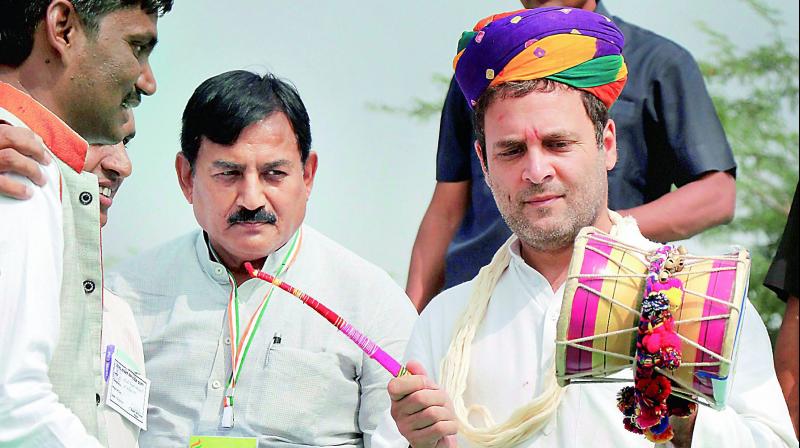 Congress vice-president Rahul Gandhi plays a musical instrument at a programme at Harij in Patan district on Monday. (Photo: PTI) Congress vice-president Rahul Gandhi plays a musical instrument at a programme at Harij in Patan district on Monday. (Photo: PTI)