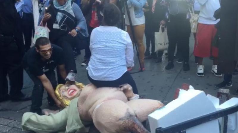 A protestor sitting on the statue that they pulled down (Photo: Twitter) A protestor sitting on the statue that they pulled down (Photo: Twitter)