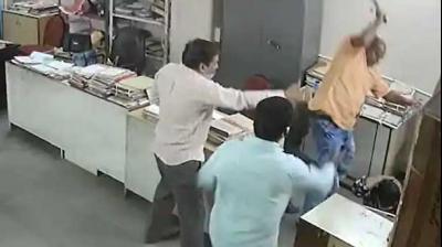 Video grab of an officer ruthlessly beating up woman staffer at AP tourism office. 