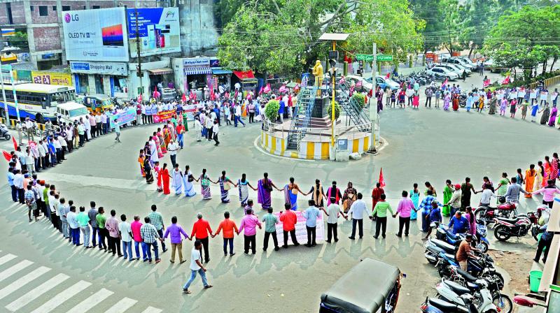 BSNL and bank employees with trade union leaders form a human chain during a protest as part of nationwide general strike against the alleged anti-worker policies of the government, at Ambedkar circle in Rajahmundry on Wednesday. (Photo: DC) BSNL and bank employees with trade union leaders form a human chain during a protest as part of nationwide general strike against the alleged anti-worker policies of the government, at Ambedkar circle in Rajahmundry on Wednesday. (Photo: DC)