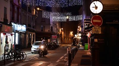 A motorcyclist rides on a deserted street in Paris on December 15, 2020, as a new 8:00 pm-6:00am curfew is implemented in France to avoid a third wave of coronavirus infections. The curfew will be waived for Christmas Eve in order to allow families to travel to celebrate together but it will be kept in place for New Year's Eve. (MARTIN BUREAU / AFP)